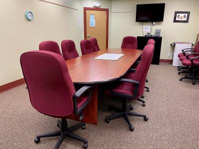 Kackaamin board room with redwood table, dark red chairs